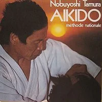 Cover of Aïkido – Méthode nationale (1977): Tamura in a white keikogi, title in white and orange